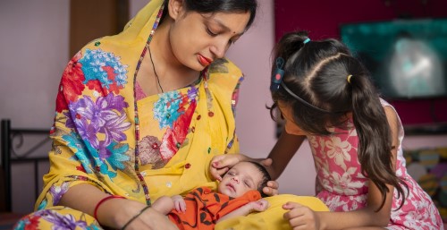 Mother and Daughter Nuture Infant